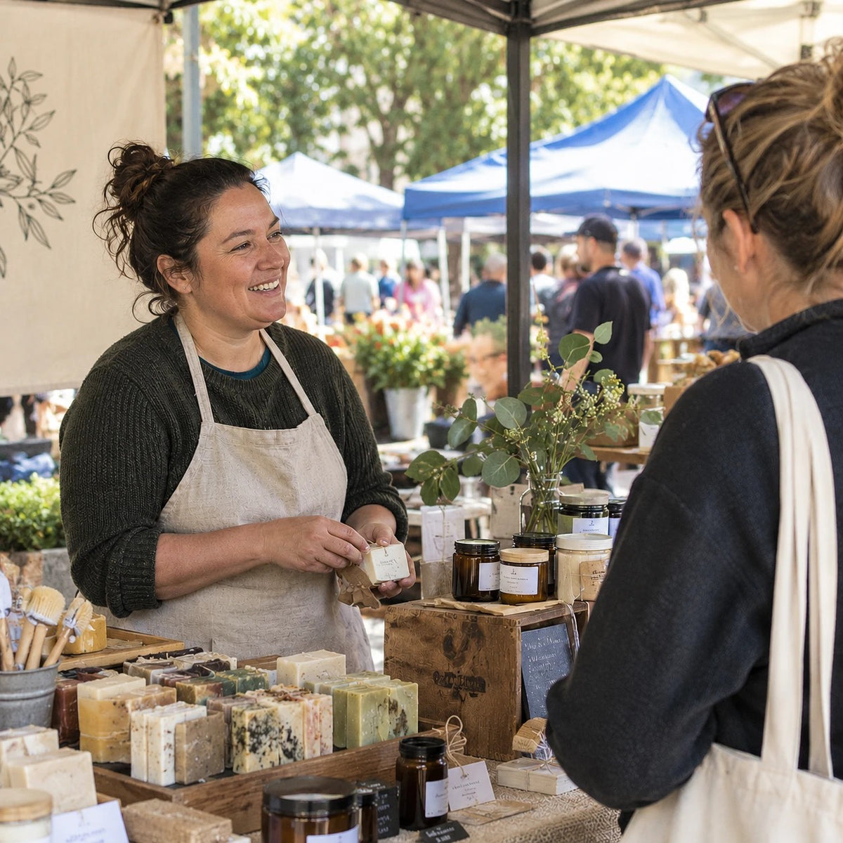 Small Business Foundations: a small business owner chatting with a customer at her market stall