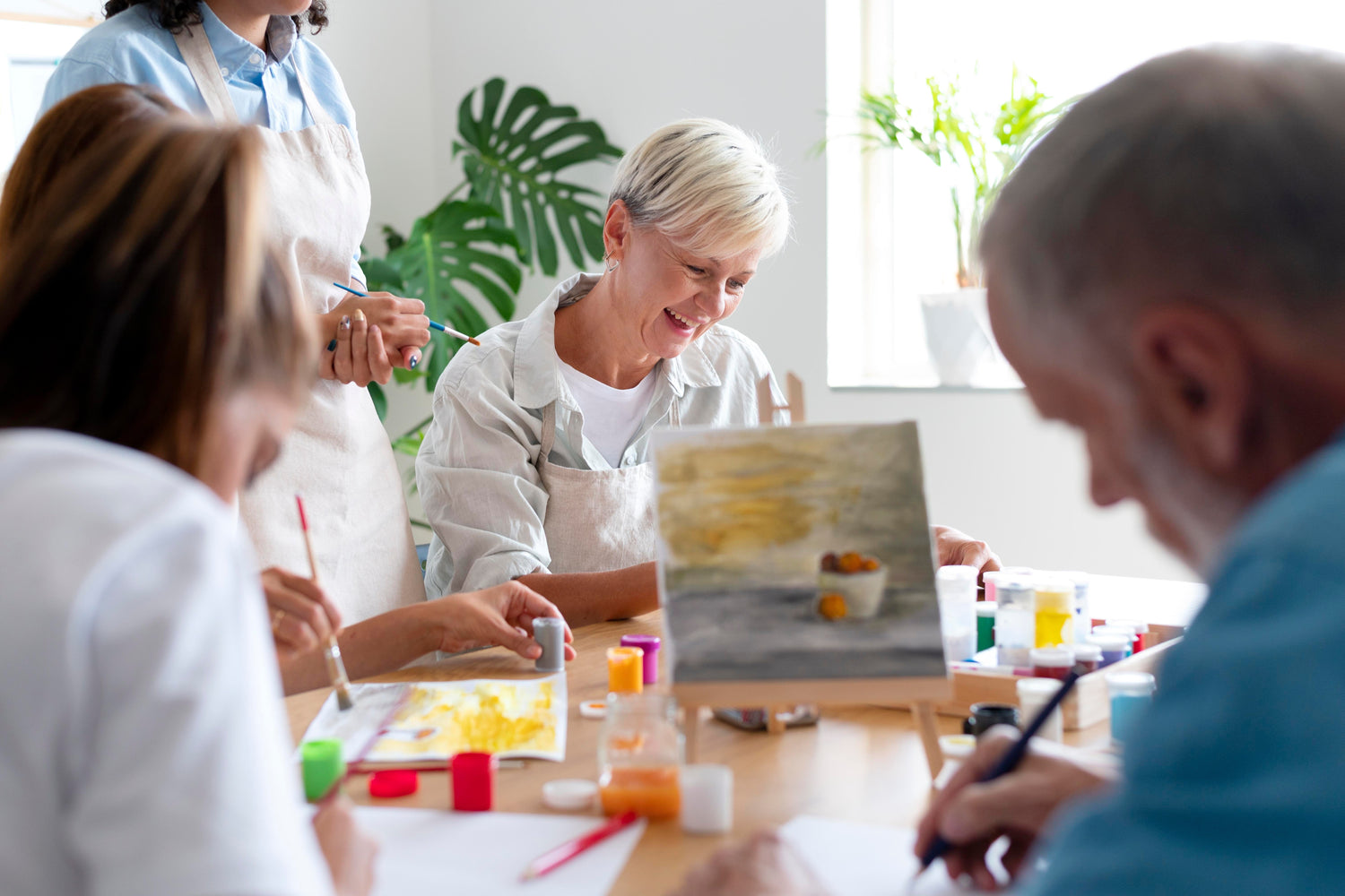 Adults participating in a group art therapy session at a community centre, using creative expression to support emotional wellbeing and connection.