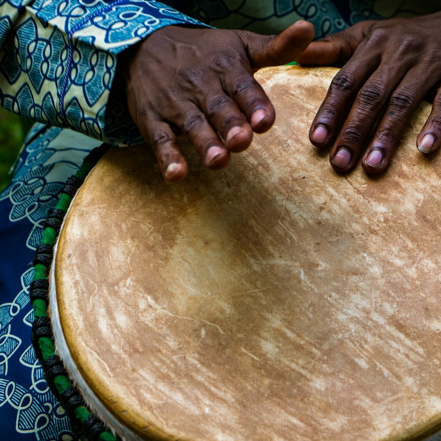 Two hands resting on the skin of a hand drum