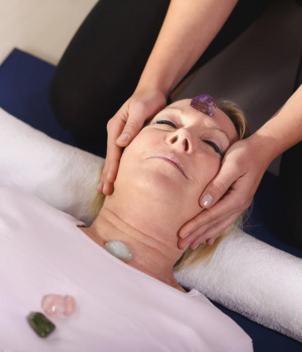 Woman experiencing crystal healing therapy