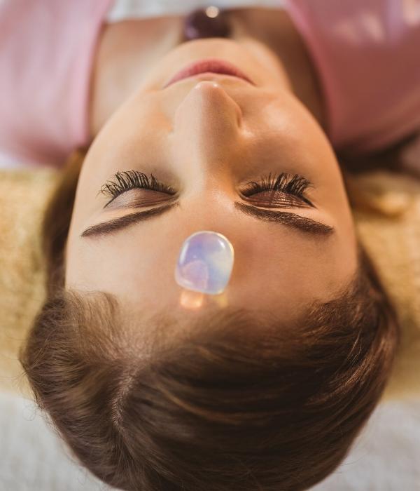 Crystal healing treatment on forehead